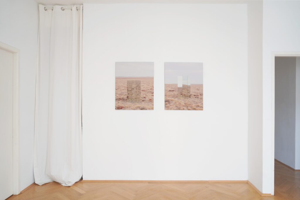 Ausstellungsansicht aus der Ausstellung "Steppe Scape". Zu sehen sind zwei Fotoarbeiten der bildenden Künstlerin Elena Kristofor. Sie tragen den Titel "Anomlie im Raum - Steppe I und II". Auf den Fotoarbeiten sind Steppenlandschaften aus dem Mongolei mit Spiegelinstallationen zu sehen.